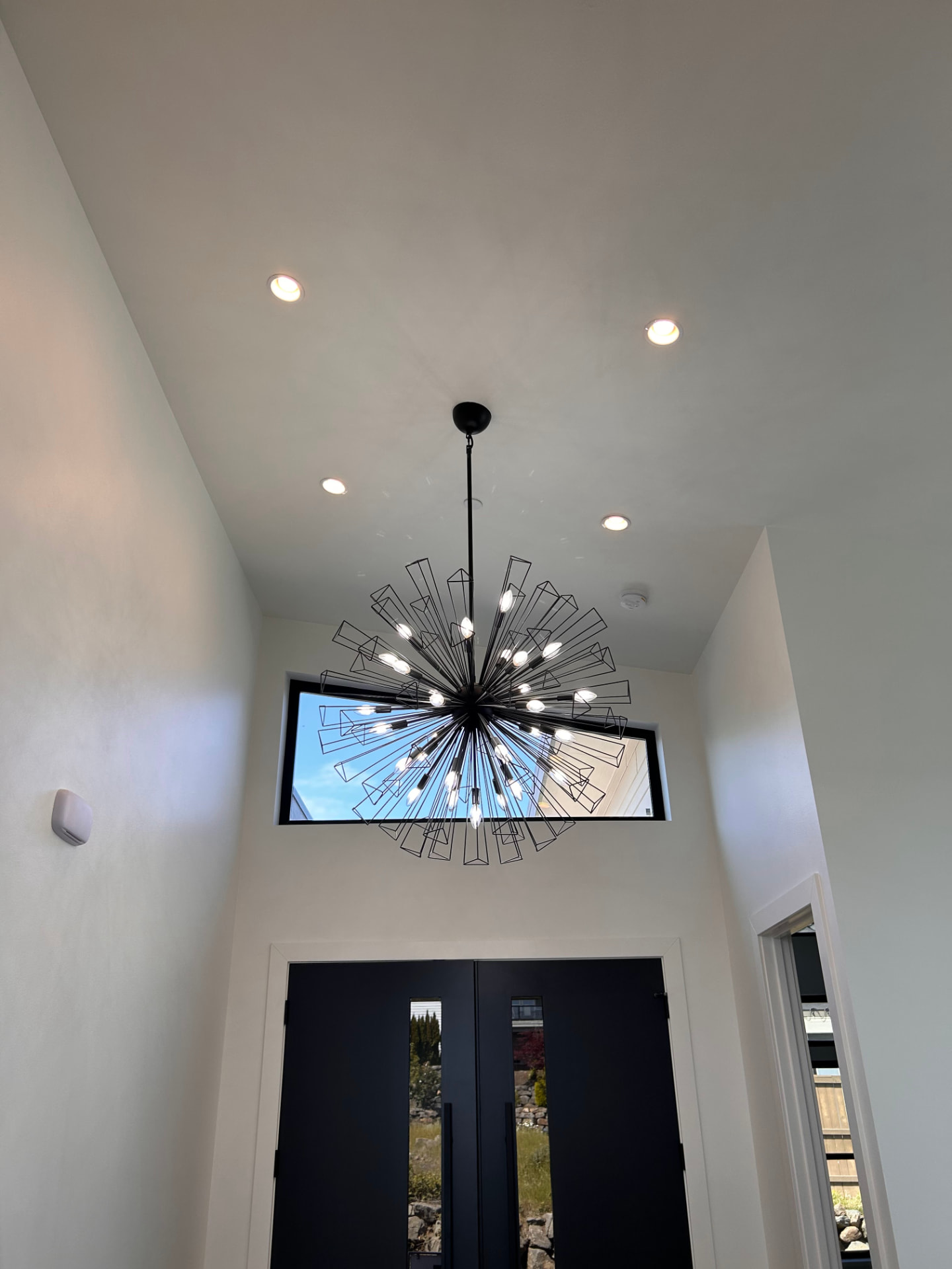 Large geometric sputnik chandelier installed in a two-story entryway
