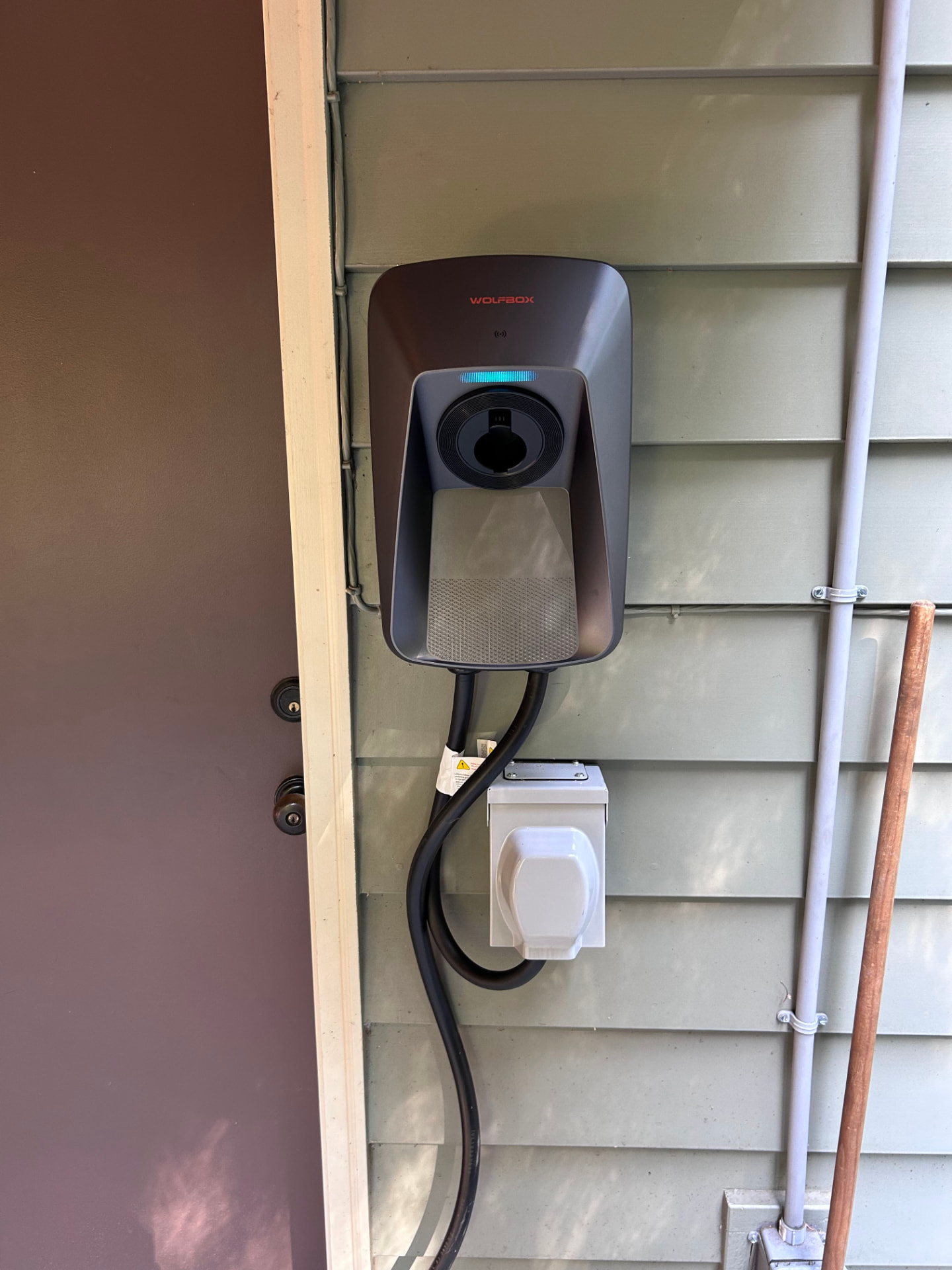 EV charger mounted on an exterior house wall